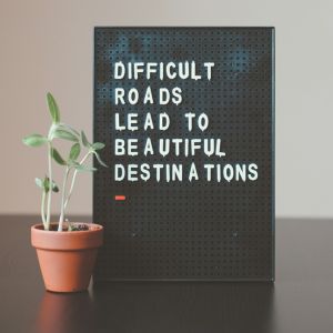 plaque on table that says difficult roads lead to beautiful destinations